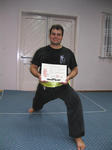 Stjepan takes a strong stance with his Yellow Sash and certificate