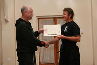 Master Hardy presenting Sifu Hardy with her Black Belt Certificate