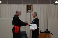 Shr Fu Ingrid Bean is presented with her Certificate as 1st Higher Level, Black Belt, by Master Hardy.