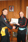 Grant is presented with his certificate by Master Bellchambers
