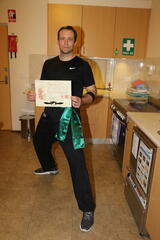 Peter, with his Green Sash and Certificate, caught in the kitchen.