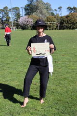 Claire - well protected from the sun, wearing her White Sash and with her well earned certificate.
